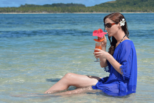 Tourist sipping cocktail in Fiji
